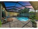 Enclosed pool area with patio furniture and dining table at 237 Albatross Rd, Rotonda West, FL 33947