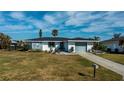 Single story home with gray garage door and newly paved driveway at 30 Oakland Hills Pl, Rotonda West, FL 33947