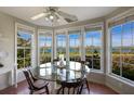 Bright breakfast nook with water views and a glass-top table at 33 Seawatch Dr, Boca Grande, FL 33921