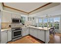 Modern kitchen with stainless steel appliances and a large island at 33 Seawatch Dr, Boca Grande, FL 33921