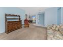 Bright living room with blue walls, plush carpeting, and views into the dining area at 36 Bunker Cir, Rotonda West, FL 33947