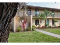 Attractive two-story condo featuring well-manicured landscaping, palm trees, and a charming exterior at 4072 Oakview Dr # C8, Punta Gorda, FL 33980