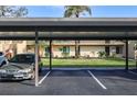 Assigned covered parking area for condo residents, and a view of the unit's manicured landscaping at 4072 Oakview Dr # C8, Punta Gorda, FL 33980