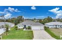 Property view showcasing a single-story house, driveway, and surrounding neighborhood at 5 Broadmoor Ln, Rotonda West, FL 33947