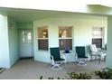 Inviting front porch with seating for two, perfect for relaxing at 5725 Greenwood Ave # 8101, North Port, FL 34287
