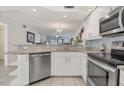 Modern kitchen with white cabinets and granite countertops at 5725 Greenwood Ave # 8101, North Port, FL 34287
