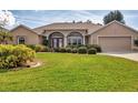 Inviting single-story home with manicured lawn and mature landscaping creating great curb appeal at 604 Boundary Blvd, Rotonda West, FL 33947