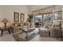 Comfortable living room with neutral tones, tile floors and views of the pool and lanai at 604 Boundary Blvd, Rotonda West, FL 33947