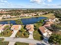Property overview showcasing a house, lake, and surrounding neighborhood at 6730 Greenview Ln, Englewood, FL 34224