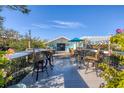 Relaxing deck overlooking the backyard with patio furniture at 8888 Bay St, Placida, FL 33946