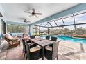 Relax on the covered lanai, complete with a dining set and a view of the inviting screened-in pool at 9548 Applin Cir, Port Charlotte, FL 33981
