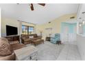 Inviting living room showcases plush seating, a large window, and a ceiling fan for added comfort at 15524 Ruston Cir, Port Charlotte, FL 33981