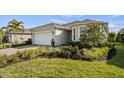 Beautiful one-story home with a lush, landscaped yard and a two-car garage at 17728 Silverspur Dr, Punta Gorda, FL 33982