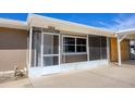 Enclosed entryway with storm door, screens, and a view of the address number above at 1922 Michigan Ave, Englewood, FL 34224