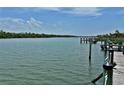 Dock with a serene water view surrounded by trees and greenery at 2255 N Beach Rd # 12, Englewood, FL 34223