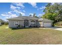 Charming single-story home featuring a well-maintained lawn and inviting curb appeal on a sunny day at 2657 Tusket Ave, North Port, FL 34286