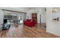 Spacious living room featuring wood floors and a view of the outdoor patio and pool at 2657 Tusket Ave, North Port, FL 34286