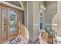 Charming front entrance with a wooden door, arched window, and cozy seating area at 2660 Sable Palm Way, Port Charlotte, FL 33953