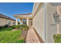 Inviting front entrance featuring a brick walkway and beautiful landscaping at 3307 Osprey Ln, Port Charlotte, FL 33953