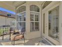 Cozy front porch with seating and an ornate glass front door at 3307 Osprey Ln, Port Charlotte, FL 33953