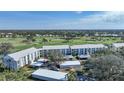 Aerial view of condo building showcasing golf course views at 404 Cerromar N Cir # 112, Venice, FL 34293