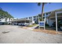 Condo building with covered parking and signage at 404 Cerromar N Cir # 112, Venice, FL 34293