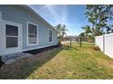 Fenced backyard featuring a well-maintained lawn, offering a private space perfect for outdoor activities and entertaining at 5031 Lucine Rd, Venice, FL 34293