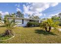 Charming single-story home with lush front yard and a well-maintained lawn at 5280 Grobe St, North Port, FL 34287