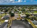 Expansive aerial view showcasing a waterfront property with a private boat dock on a sunny day at 621 Tarpon Way, Punta Gorda, FL 33950