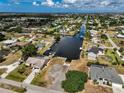 High-angle aerial view of the home and neighborhood with a canal and private dock at 621 Tarpon Way, Punta Gorda, FL 33950