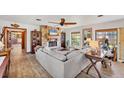 Bright living room with an oversized sectional, wood floors, and natural light at 681 Olive St, Englewood, FL 34223