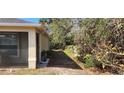 Side yard with a pathway, some vegetation, and a rain barrel at 6981 Tuxedo St, Englewood, FL 34224