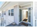 Inviting entrance of home features covered porch with turtle statue, open door, and views of interior at 7482 Palm Island Dr # 2522, Placida, FL 33946