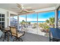 Relaxing screened-in porch with beautiful ocean views, a ceiling fan, and comfortable seating area at 7482 Palm Island Dr # 2522, Placida, FL 33946