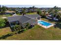 Aerial view of backyard with a swimming pool surrounded by a fence at 84 Caddy Rd, Rotonda West, FL 33947