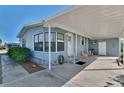 Exterior view featuring the covered parking and a well-maintained yard with green grass at 8431 Nighthawk Dr, Englewood, FL 34224