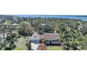 Beautiful aerial view of a waterfront home surrounded by lush trees and well-manicured landscaping at 955 Morrison Ave, Englewood, FL 34223