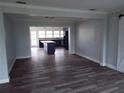 Open living space with wood floors flows into a kitchen area, offering modern living at 112 Gause Dr, Venice, FL 34293