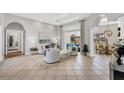Bright and airy living room with tile flooring, neutral colors, and stylish furnishings at 15 Boca Royale Blvd, Englewood, FL 34223