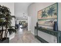 Open foyer with tiled floor, decorative console table, leads to the living room at 170 Long Meadow Ln, Rotonda West, FL 33947