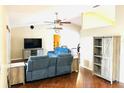 Open living room area with high ceilings, ceiling fans and barn door shelving at 18198 Griffen Ave, Port Charlotte, FL 33948