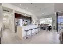 Modern kitchen with stainless steel appliances, island with seating, and adjacent dining area at 19 Windward Rd, Placida, FL 33946