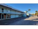 Exterior view of the two story light blue property with a parking lot at 5055 N Beach Rd # 203, Englewood, FL 34223