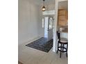 Bright foyer featuring tiled flooring, an ornate rug, and a view of the front door at 8937 Bantry Bay Blvd, Englewood, FL 34224