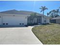 Charming home with a well-maintained lawn and a curved driveway leading to the garage at 8937 Bantry Bay Blvd, Englewood, FL 34224