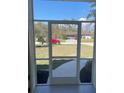 View from the screened porch looks out to the front yard and the neighborhood street at 8937 Bantry Bay Blvd, Englewood, FL 34224