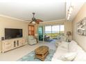 Comfortable living room features neutral decor and large sliding doors to a screened lanai at 9203 Griggs Rd # 301, Englewood, FL 34224