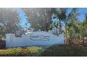 The Grande Preserve on Lemon Bay sign welcomes visitors with lush landscaping and clear signage at 9203 Griggs Rd # 301, Englewood, FL 34224