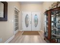 Entryway featuring light floors and a decorative glass double door at 1320 Bayshore Dr, Englewood, FL 34223