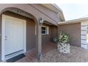 Inviting entryway with brick-laid walkway, decorative plant stand, and stylish arched doorway at 1918 Greenlawn Dr, Englewood, FL 34223